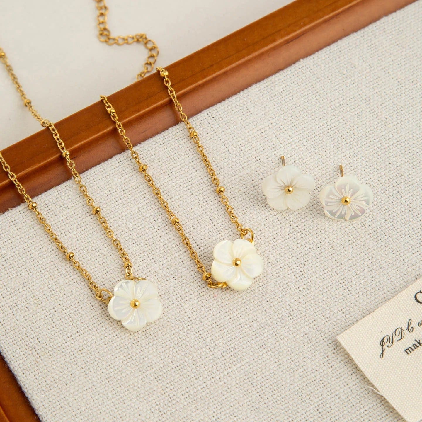 Mother of pearl flower stud earrings worn