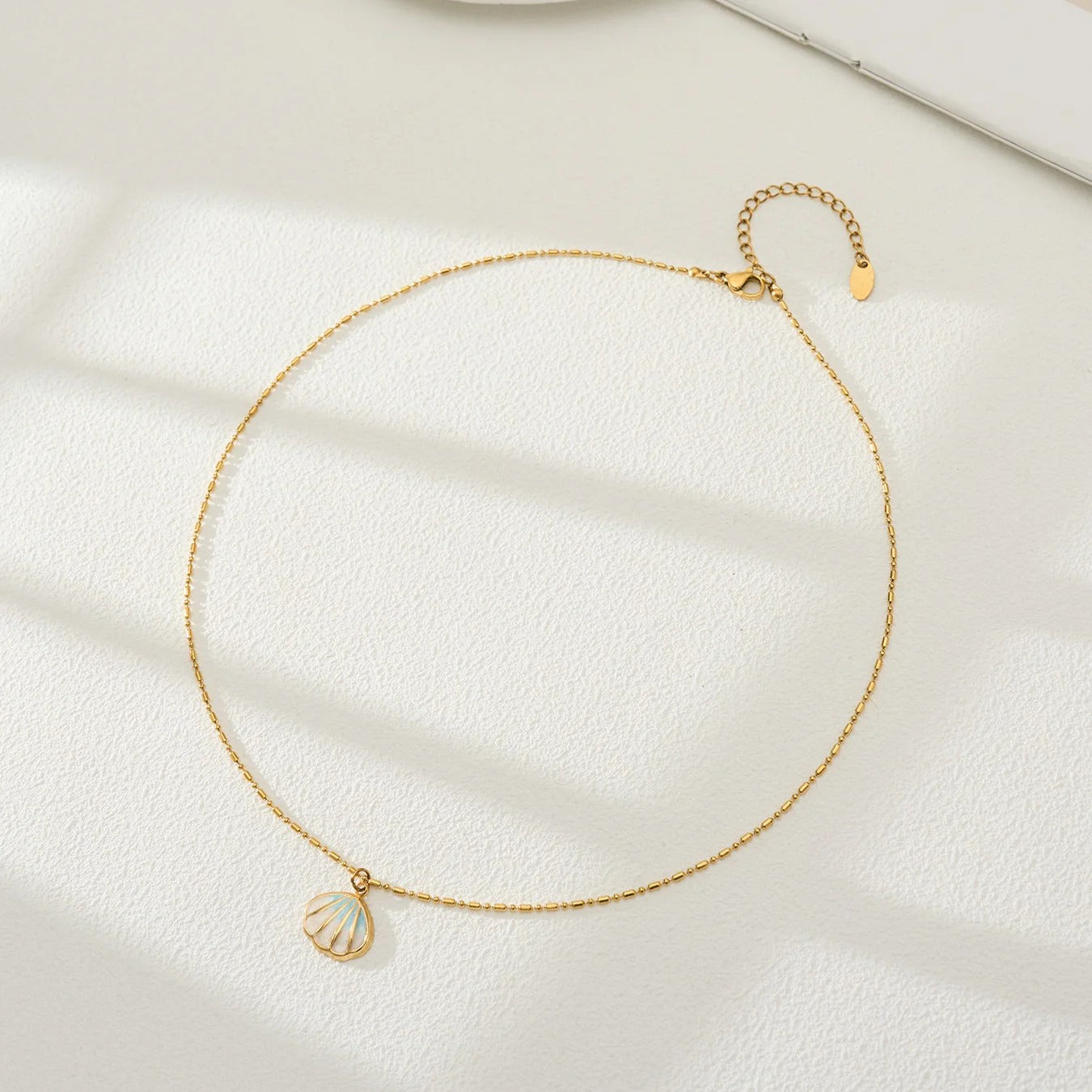 Gold Plated Shell Pendant Necklace - Style A, flat lay on white surface