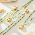 Mint green stone bead necklace with gold pearl pendant flat lay